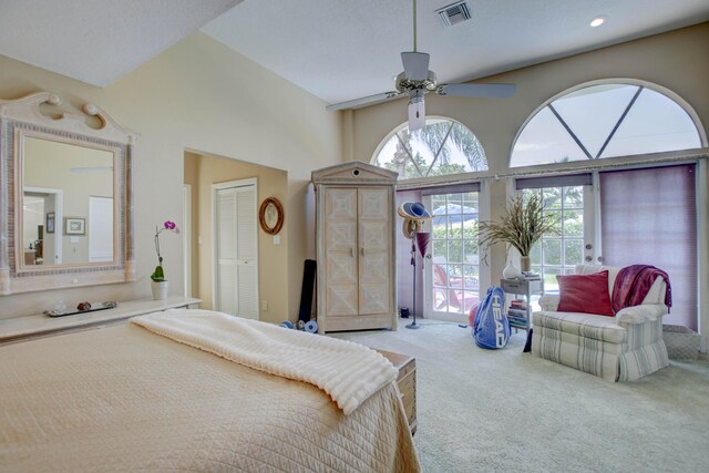 carpeted bedroom featuring ceiling fan, vaulted ceiling, access to exterior, and a closet