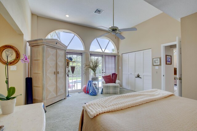 carpeted bedroom with ceiling fan, a high ceiling, access to outside, and a closet