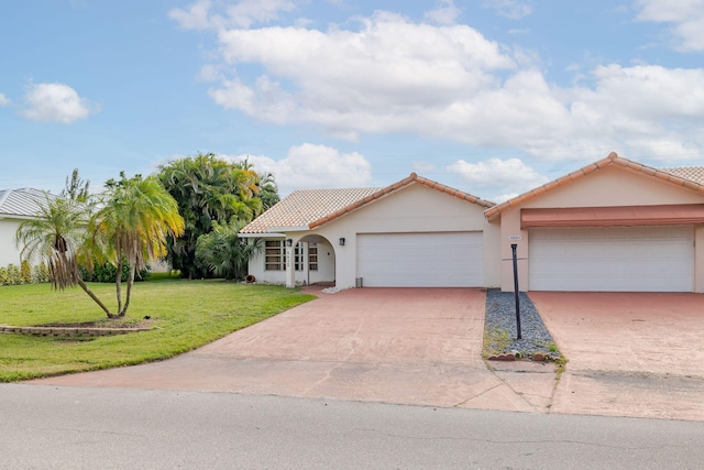 view of front of property with a front lawn and a garage