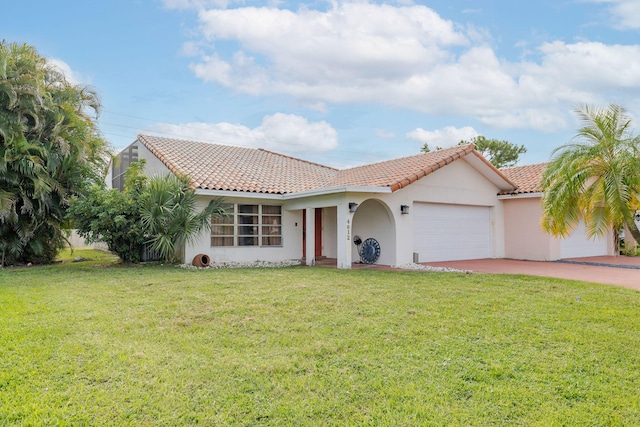 mediterranean / spanish house with a garage and a front yard