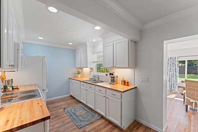 kitchen with white cabinetry, hardwood / wood-style floors, and butcher block countertops