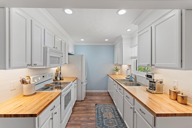 kitchen featuring butcher block counters, white cabinetry, sink, white appliances, and crown molding