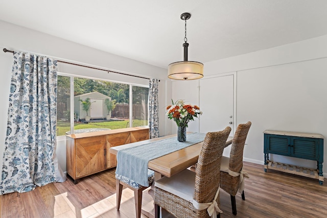 dining space featuring wood-type flooring