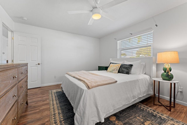 bedroom with ceiling fan and dark hardwood / wood-style floors