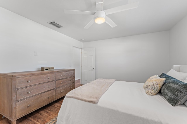 bedroom with ceiling fan and dark hardwood / wood-style flooring