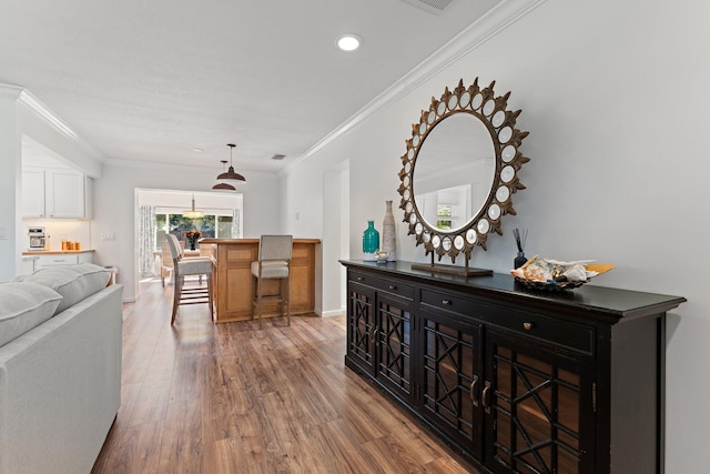 hallway with hardwood / wood-style flooring and crown molding