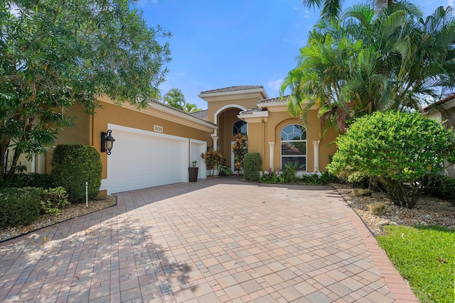 mediterranean / spanish-style home with a garage