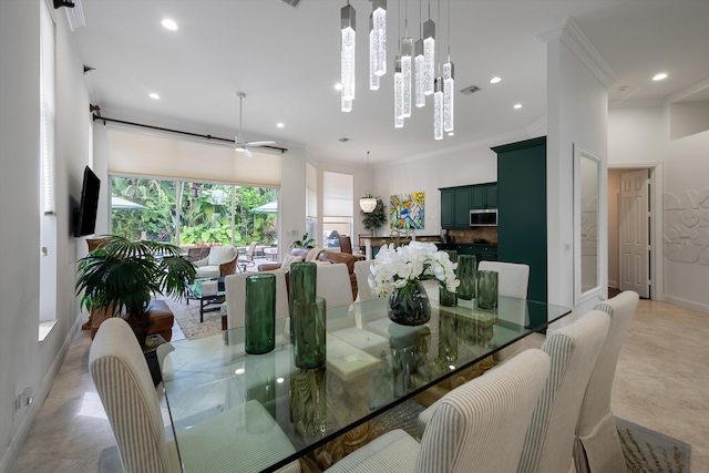 dining space with ceiling fan with notable chandelier and crown molding