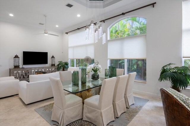 dining room with ceiling fan, light tile patterned floors, and ornamental molding