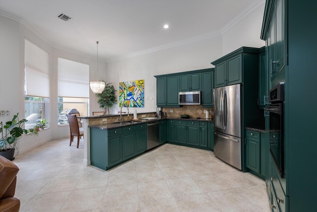 kitchen with pendant lighting, ornamental molding, sink, appliances with stainless steel finishes, and decorative backsplash