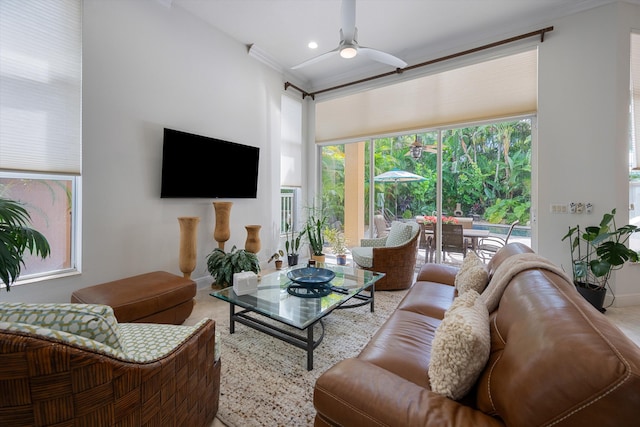 living room featuring ornamental molding and ceiling fan