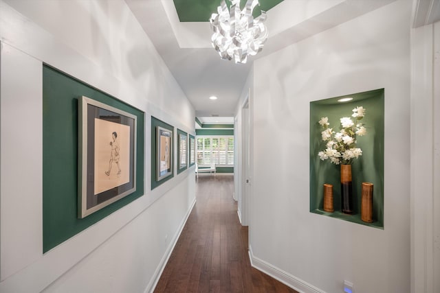 hallway featuring a notable chandelier and dark hardwood / wood-style floors