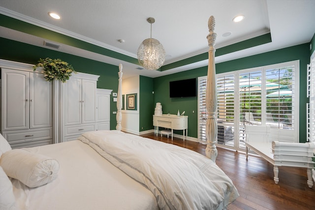 bedroom featuring a raised ceiling, crown molding, access to exterior, and dark hardwood / wood-style flooring