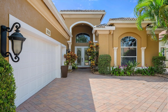 property entrance featuring french doors and a garage