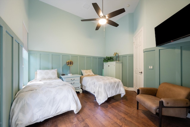 bedroom with ceiling fan, dark hardwood / wood-style flooring, and high vaulted ceiling