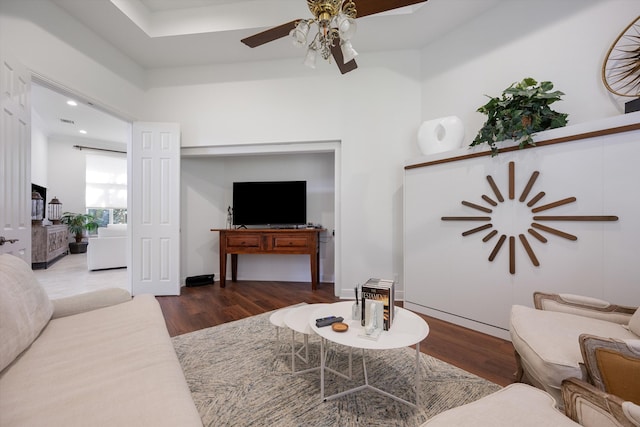 living room with dark hardwood / wood-style floors and ceiling fan