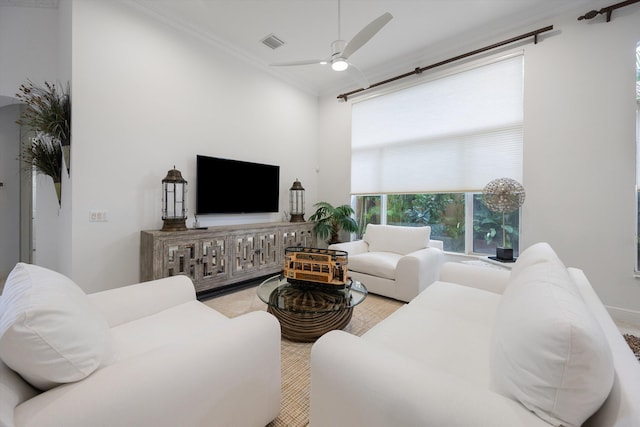 living room featuring crown molding and ceiling fan