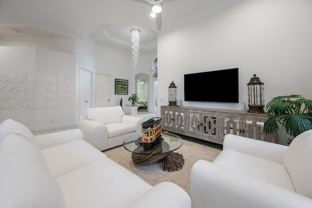 living room featuring a towering ceiling and ceiling fan