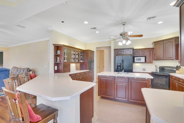 kitchen featuring black appliances, kitchen peninsula, ornamental molding, and ceiling fan