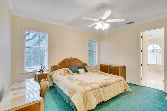 carpeted bedroom with multiple windows, ceiling fan, and ensuite bathroom