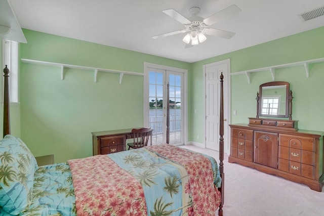 bedroom featuring ceiling fan, light colored carpet, access to exterior, and french doors