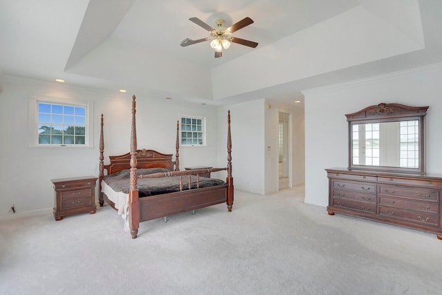 bedroom with ceiling fan, light carpet, and multiple windows