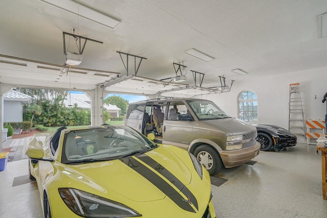 garage with a garage door opener and a carport