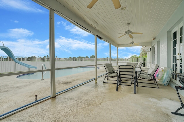 unfurnished sunroom with ceiling fan and wood ceiling