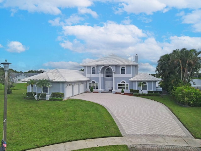 mediterranean / spanish-style home with a garage and a front yard