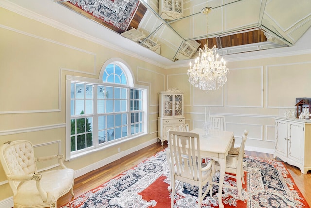 dining space featuring an inviting chandelier, crown molding, a high ceiling, and hardwood / wood-style flooring