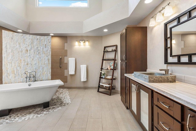 bathroom with vanity and separate shower and tub