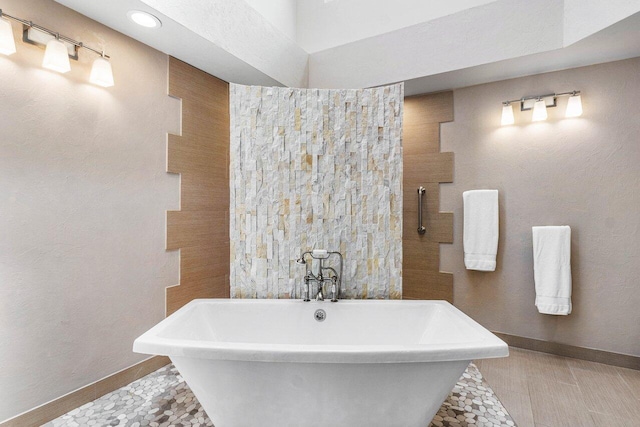 bathroom with tile patterned floors and a tub