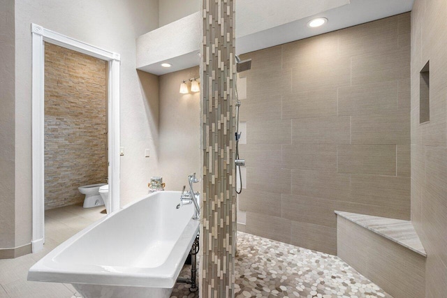 bathroom featuring toilet, tile patterned floors, and separate shower and tub