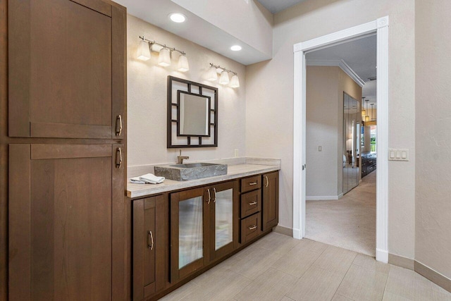 bathroom with vanity and ornamental molding