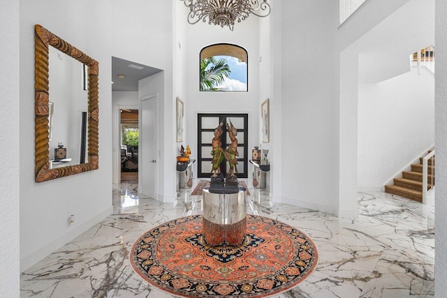 foyer entrance featuring a towering ceiling