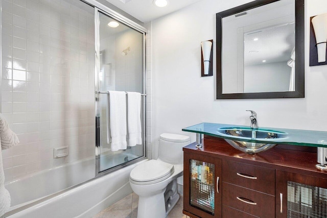 full bathroom featuring toilet, shower / bath combination with glass door, vanity, and tile patterned floors