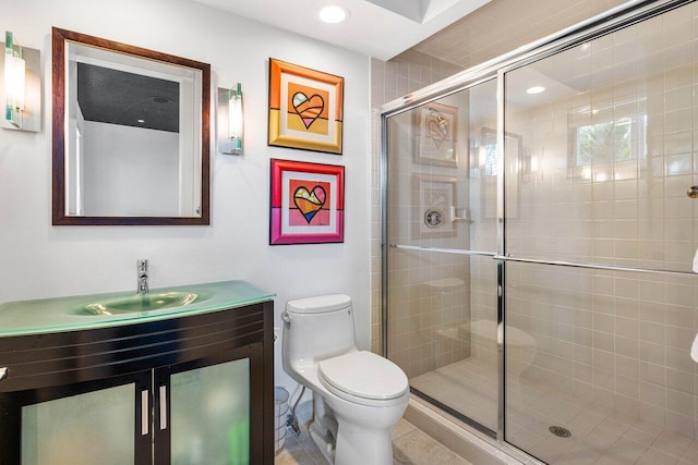 bathroom featuring tile patterned floors, vanity, toilet, and an enclosed shower