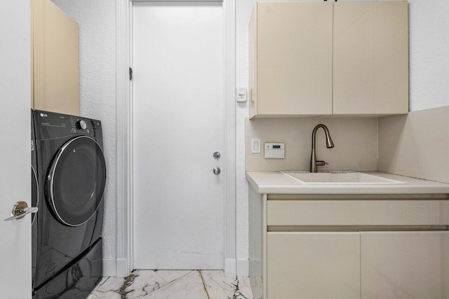 washroom featuring cabinets, sink, and washer / dryer