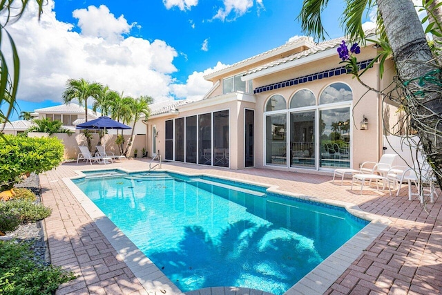 view of pool featuring a patio area and a sunroom