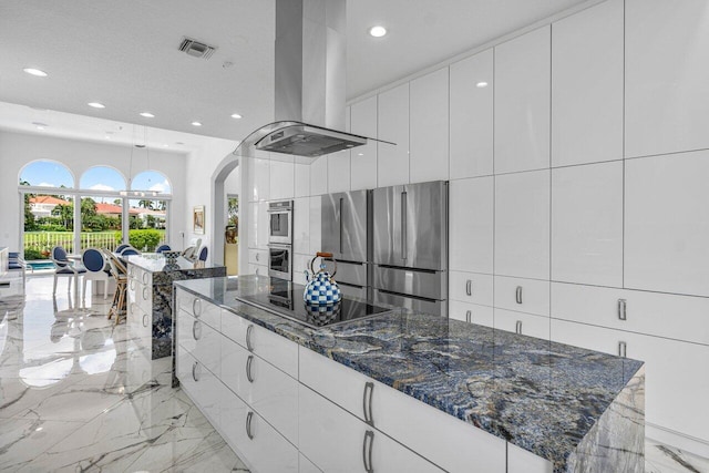 kitchen featuring white cabinets, stainless steel appliances, a textured ceiling, and island range hood