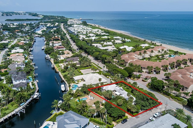 bird's eye view with a water view and a beach view