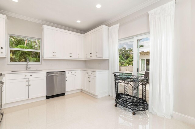 kitchen featuring sink, stainless steel dishwasher, ornamental molding, a healthy amount of sunlight, and white cabinets