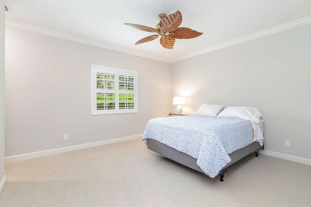 carpeted bedroom featuring crown molding and ceiling fan