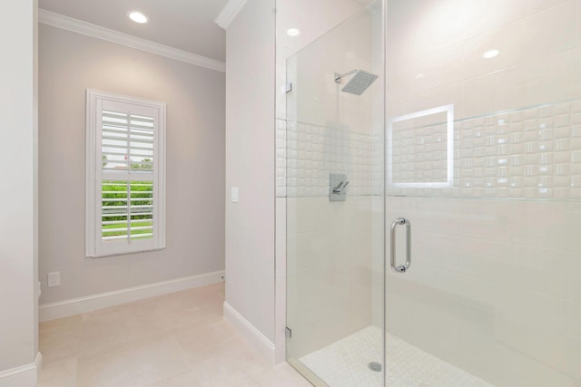 bathroom with a shower with shower door and ornamental molding