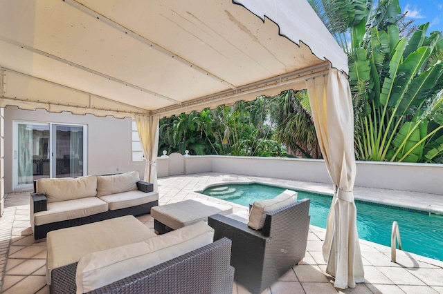 view of pool with an outdoor living space and a patio area