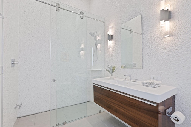 bathroom featuring vanity, a shower with shower door, and tile patterned flooring