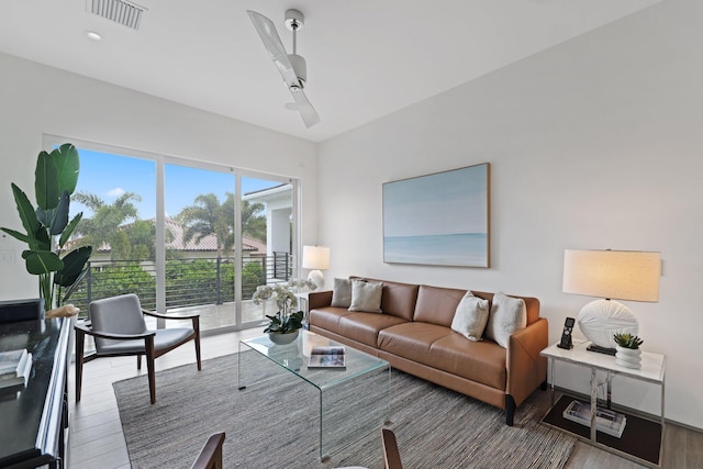 living room featuring ceiling fan and hardwood / wood-style floors