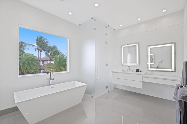 bathroom with plus walk in shower, tile patterned floors, and vanity