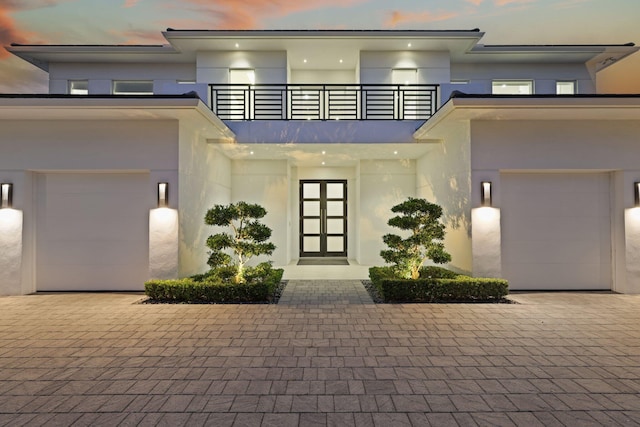 view of front of home with a garage and french doors