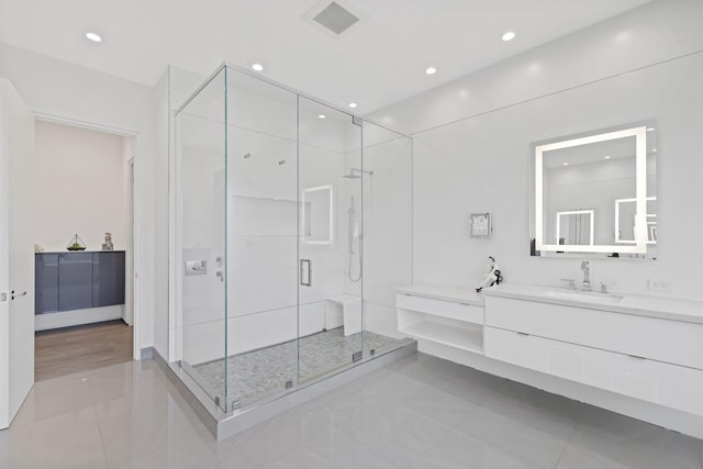 bathroom featuring walk in shower and vanity